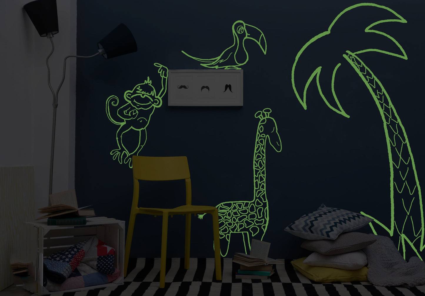 Jungle theme glowing on a playroom wall